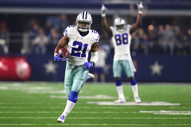 ARLINGTON, TX - DECEMBER 26: Ezekiel Elliott #21 of the Dallas Cowboys runs for a touchdown as teammate Dez Bryant #88 celebrates as the Cowboys play the Detroit Lions during the first half at AT&T Stadium on December 26, 2016 in Arlington, Texas. (Photo by Tom Pennington/Getty Images)