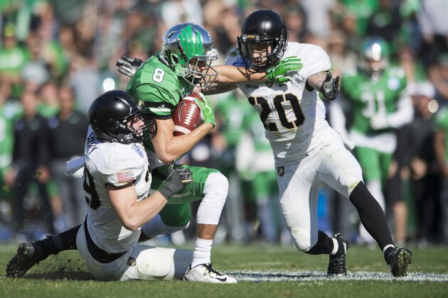 DALLAS, TX - DECEMBER 27:  Rico Bussey Jr. #8 of the North Texas Mean Green is brought down after the catch by the Army Black Knights defense during the 1st half of the Zaxby's Heart of Dallas Bowl on December 27, 2016 at the Cotton Bowl in Dallas, Texas.  (Photo by Cooper Neill/Getty Images)
