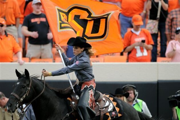 Oklahoma State Cowboys mascot Bullet and the OSU Spirit Rider are pictured during an NCAA college football game between UTSA and Oklahoma St in Stillwater, Okla., Saturday, Sept. 19, 2015.(AP Photo/Brody Schmidt)