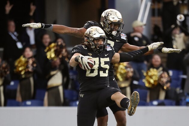 ANNAPOLIS, MD - DECEMBER 27: Tight end Cam Serigne #85 of the Wake Forest Demon Deacons celebrates with teammate wide receiver Scotty Washington #7 after scoring a first quarter touchdown against the Temple Owls during the Military Bowl at Navy-Marines Memorial Stadium on December 27, 2016 in Annapolis, Maryland. (Photo by Matt Hazlett/Getty Images)