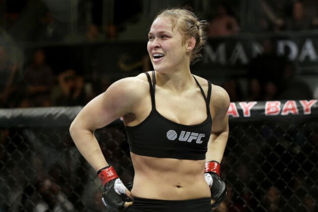 FILE - In this Feb. 22, 2014, file photo, Ronda Rousey looks around after defeating Sara McMann in a UFC 170 mixed martial arts women's bantamweight title bout in Las Vegas. Rousey says her bantamweight title shot against Amanda Nunes at UFC 207 will be one of her final mixed martial arts bouts. Rousey spoke about her fight Tuesday, Nov. 1, 2016, during an appearance on Ellen DeGeneres’ talk show. (AP Photo/Isaac Brekken, File)