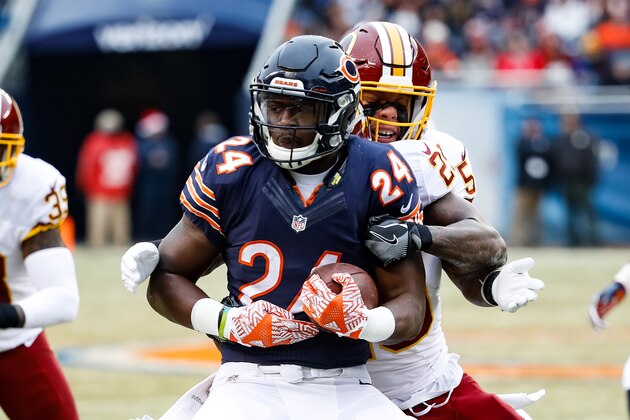 CHICAGO, IL - DECEMBER 24:  Jordan Howard #24 of the Chicago Bears carries the football against  Duke Ihenacho #29 and  Mason Foster #54 of the Washington Redskins in the first quarter at Soldier Field on December 24, 2016 in Chicago, Illinois.  (Photo by Joe Robbins/Getty Images)