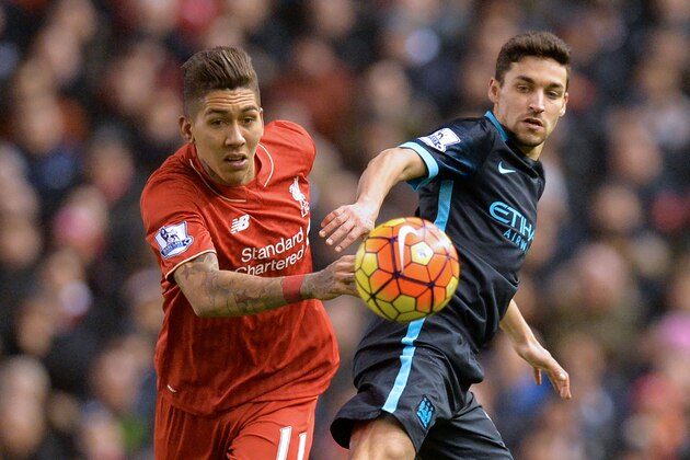 Liverpool's Brazilian midfielder Roberto Firmino (L) vies with Manchester City's Spanish midfielder Jesus Navas during the English Premier League football match between Liverpool and Manchester City at Anfield in Liverpool, northwest England on March 2, 2016.
Liverpool won the game 3-0. / AFP / Paul ELLIS / RESTRICTED TO EDITORIAL USE. No use with unauthorized audio, video, data, fixture lists, club/league logos or 'live' services. Online in-match use limited to 75 images, no video emulation. No use in betting, games or single club/league/player publications.  /         (Photo credit should read PAUL ELLIS/AFP/Getty Images)