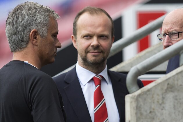 Manchester United's executive vice-chairman Ed Woodward (C) listens as Manchester United's Portuguese manager Jose Mourinho (L) talks with former Manchester United player Bobby Charlton following the pre-season friendly football match between Wigan Athletic and Manchester United at the DW stadium in Wigan, northwest England, on July 16, 2016.  / AFP / JON SUPER / RESTRICTED TO EDITORIAL USE. No use with unauthorized audio, video, data, fixture lists, club/league logos or 'live' services. Online in-match use limited to 75 images, no video emulation. No use in betting, games or single club/league/player publications.  /         (Photo credit should read JON SUPER/AFP/Getty Images)