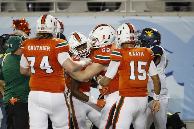ORLANDO, FL - DECEMBER 28: Ahmmon Richards #82 of the Miami Hurricanes is mobbed by teammates after a 51-yard touchdown reception against the West Virginia Mountaineers in the second quarter of the Russell Athletic Bowl at Camping World Stadium on December 28, 2016 in Orlando, Florida. (Photo by Joe Robbins/Getty Images)