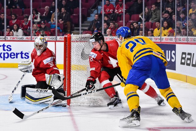 MONTREAL, QC - DECEMBER 28:  Goaltender Joren van Pottelberghe #30 of Team Switzerland makes a pad save on Joel Eriksson Ek #20 of Team Sweden while teammate Colin Gerber #24 defends during the 2017 IIHF World Junior Championship preliminary round game at the Bell Centre on December 28, 2016 in Montreal, Quebec, Canada.  Team Sweden defeated Team Switzerland 4-2.  (Photo by Minas Panagiotakis/Getty Images)