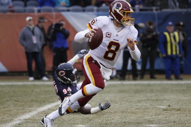 Washington Redskins quarterback Kirk Cousins (8) runs from Chicago Bears outside linebacker Leonard Floyd (94) during the first half of an NFL football game, Saturday, Dec. 24, 2016, in Chicago. (AP Photo/Nam Y. Huh)