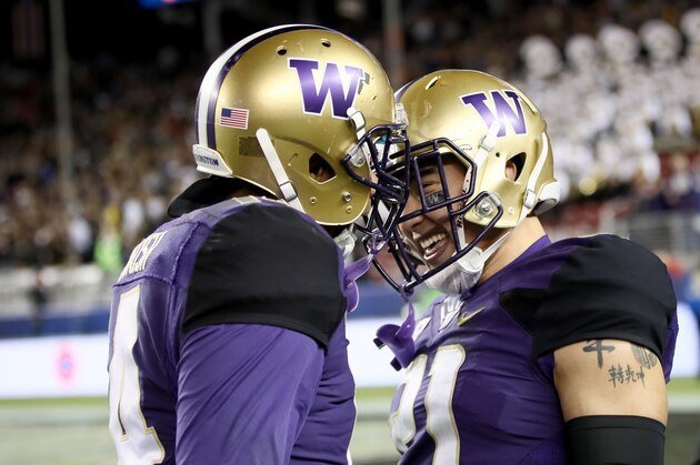 SANTA CLARA, CA - DECEMBER 02:  Taylor Rapp #21 of the Washington Huskies is congratulated by Jojo McIntosh #14 after making his interception against the Colorado Buffaloes in the Pac-12 Championship game at Levi's Stadium on December 2, 2016 in Santa Clara, California.  (Photo by Robert Reiners/Getty Images)