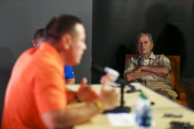 Gus Manning (right) looks on as Tennessee head coach Butch Jones speaks to the media
