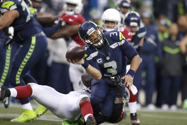 SEATTLE, WA - DECEMBER 24:  Quarterback Russell Wilson #3 of the Seattle Seahawks passes as he's tackled by the Arizona Cardinals at CenturyLink Field on December 24, 2016 in Seattle, Washington.  (Photo by Otto Greule Jr/Getty Images)