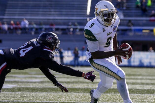 South Florida quarterback Quinton Flowers (9) gets around South Carolina defensive back D.J. Smith (24) for a touchdown during the first half of the Birmingham Bowl NCAA college football game, Thursday, Dec. 29, 2016, in Birmingham. (AP Photo/Butch Dill)