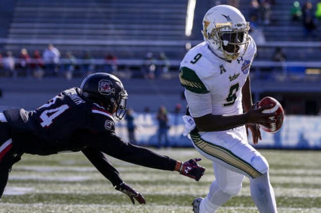 South Florida quarterback Quinton Flowers (9) gets around South Carolina defensive back D.J. Smith (24) for a touchdown during the first half of the Birmingham Bowl NCAA college football game, Thursday, Dec. 29, 2016, in Birmingham. (AP Photo/Butch Dill)
