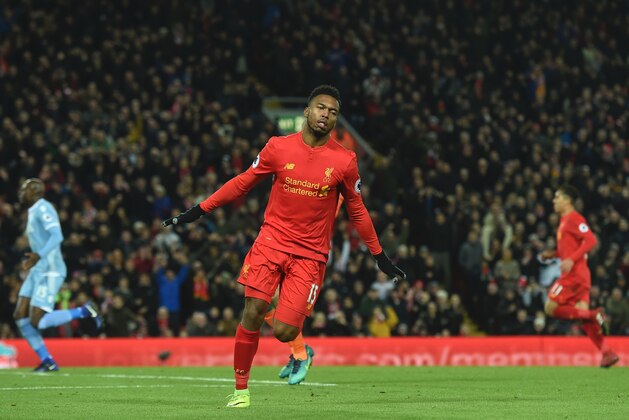 Liverpool's English striker Daniel Sturridge celebrates scoring their fourth goal during the English Premier League football match between Liverpool and Stoke City at Anfield in Liverpool, north west England on December 27, 2016. / AFP / Paul ELLIS / RESTRICTED TO EDITORIAL USE. No use with unauthorized audio, video, data, fixture lists, club/league logos or 'live' services. Online in-match use limited to 75 images, no video emulation. No use in betting, games or single club/league/player publications.  /         (Photo credit should read PAUL ELLIS/AFP/Getty Images)