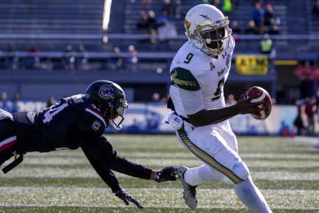 South Florida quarterback Quinton Flowers (9) gets around South Carolina defensive back D.J. Smith (24) for a touchdown during the first half of the Birmingham Bowl NCAA college football game, Thursday, Dec. 29, 2016, in Birmingham, Ala. (AP Photo/Butch Dill)