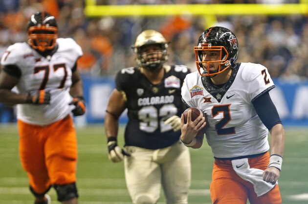 SAN ANTONIO,TX - DECEMBER 29: QB Darius Curry #2 of the Oklahoma State Cowboys scrambles after a pass reception against Colorado Cowboysin the Valero Alamo Bowl at the Alamodome on December 29, 2016 in San Antonio, Texas.  (Photo by Ronald Cortes/Getty Images)