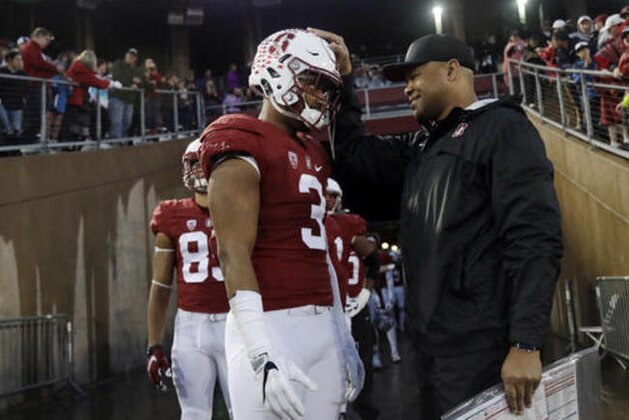 Stanford head coach David Shaw , right, pats wide receiver Michael Rector (3) on the head during introductions before an NCAA college football game against Rice Saturday, Nov. 26, 2016, in Stanford, Calif. (AP Photo/Marcio Jose Sanchez)