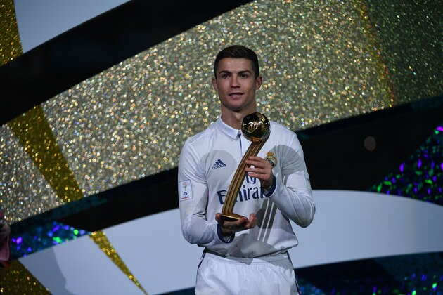 Real Madrid's forward Cristiano Ronaldo poses as he holds the Golden Ball trophy after winning the Club World Cup football final match between Kashima Antlers of Japan and Real Madrid of Spain at Yokohama International stadium in Yokohama on December 18, 2016. / AFP / Toshifumi KITAMURA        (Photo credit should read TOSHIFUMI KITAMURA/AFP/Getty Images)