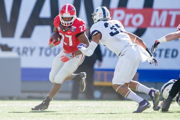MEMPHIS, TN - DECEMBER 30: Running back Nick Chubb #27 of the Georgia Bulldogs looks to maneuver by linebacker Sammy Douglas #35 of the TCU Horned Frogs at Liberty Bowl Memorial Stadium on December 30, 2016 in Memphis, Tennessee. At halftime the TCU Horned Frogs leads the Georgia Bulldogs 16-14. (Photo by Michael Chang/Getty Images)