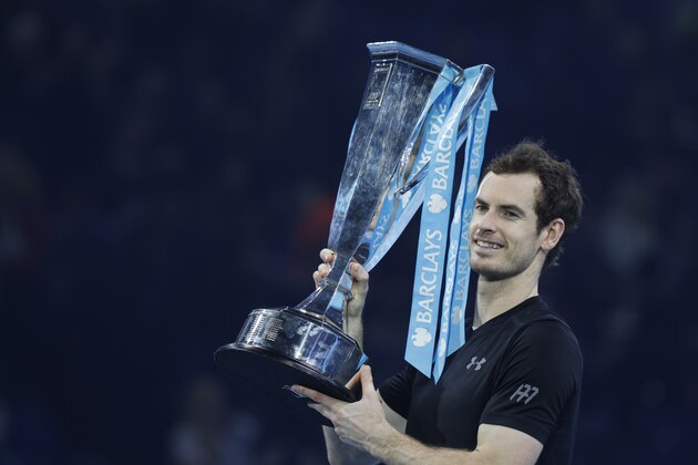 Britain's Andy Murray celebrate with the trophy after winning the men's singles final against Serbia's Novak Djokovic on the eighth and final day of the ATP World Tour Finals tennis tournament in London on November 20, 2016. / AFP / Adrian DENNIS        (Photo credit should read ADRIAN DENNIS/AFP/Getty Images)