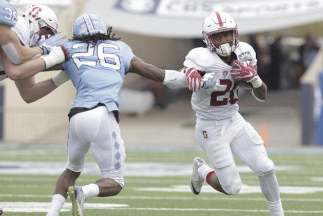Stanford running back Bryce Love, right, shrugs off North Carolina safety Dominiqie Green in the second quarter of the Sun Bowl NCAA college football game, Friday, Dec. 30, 2016, in El Paso, Texas. (AP Photo/Mark Lambie)