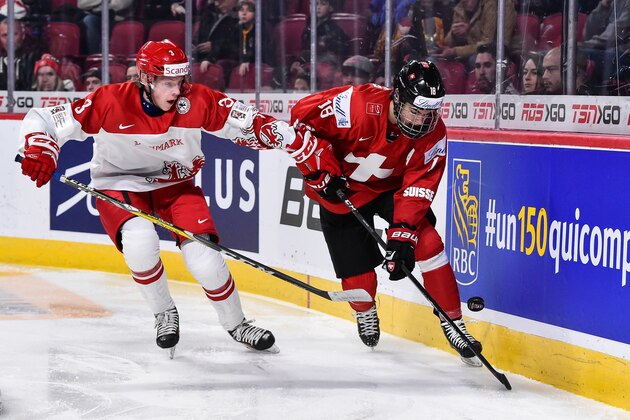 MONTREAL, QC - DECEMBER 30:  Nico Hischier #18 of Team Switzerland skates the puck against Anders Koch #3 of Team Denmark during the 2017 IIHF World Junior Championship preliminary round game at the Bell Centre on December 30, 2016 in Montreal, Quebec, Canada.  (Photo by Minas Panagiotakis/Getty Images)