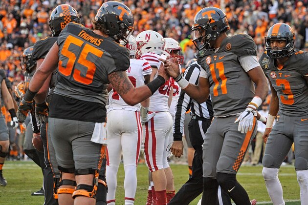 NASHVILLE, TN - DECEMBER 30: Joshua Dobbs #11 of the University of Tennessee Volunteers is congratulated by teammate Coleman Thomas #55 after scoring a touchdown against the Nebraska Cornhuskers during the first half of the Franklin American Mortgage Music City Bowl at Nissan Stadium on December 30, 2016 in Nashville, Tennessee. (Photo by Frederick Breedon/Getty Images)