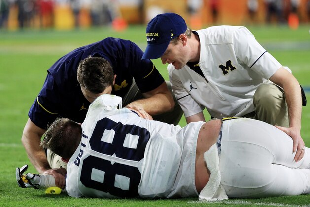 MIAMI GARDENS, FL - DECEMBER 30:  Jake Butt #88 of the Michigan Wolverines receives medical attention in the first half against the Florida State Seminoles during the Capitol One Orange Bowl at Sun Life Stadium on December 30, 2016 in Miami Gardens, Florida.  (Photo by Mike Ehrmann/Getty Images)