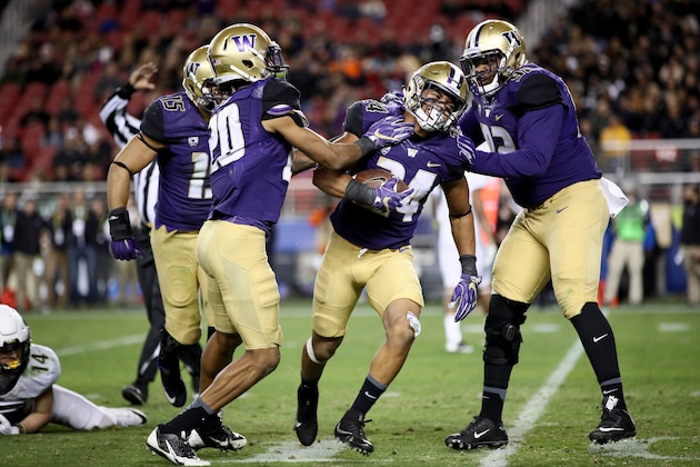 SANTA CLARA, CA - DECEMBER 02:  Ezekiel Turner #24 of the Washington Huskies is congratulated by Kevin King #20 and Jaylen Johnson #92 after he intercepted the ball against the Colorado Buffaloes during the Pac-12 Championship game at Levi's Stadium on December 2, 2016 in Santa Clara, California.  (Photo by Robert Reiners/Getty Images)