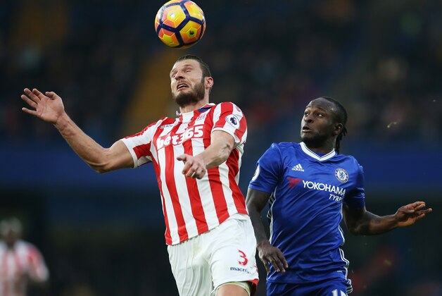 LONDON, ENGLAND - DECEMBER 31: Erik Pieters of Stoke City and Victor Moses of Chelsea compete for the ball during the Premier League match between Chelsea and Stoke City at Stamford Bridge on December 31, 2016 in London, England.  (Photo by Steve Bardens/Getty Images)