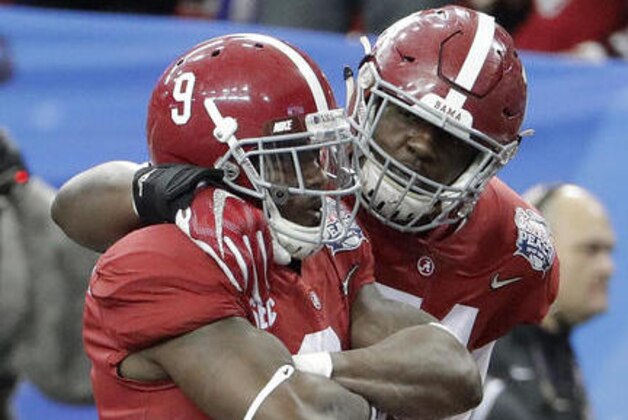Alabama offensive lineman Cam Robinson, right, celebrates the touchdown of Alabama running back Bo Scarbrough (9) during the first half of the Peach Bowl NCAA college football playoff game, Saturday, Dec. 31, 2016, in Atlanta. (AP Photo/David Goldman)