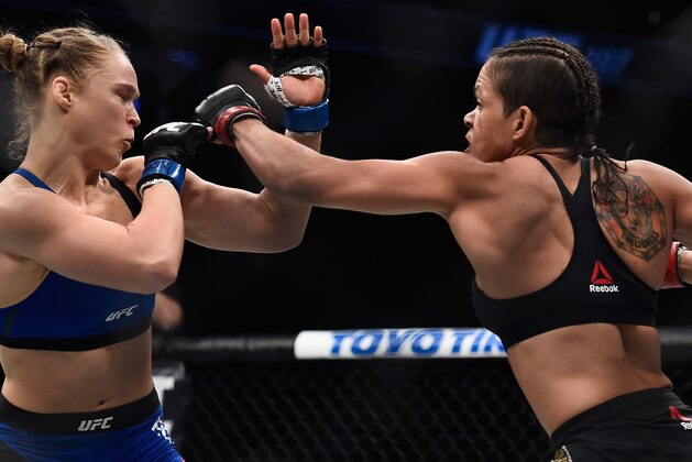 LAS VEGAS, NV - DECEMBER 30:  (R-L) Amanda Nunes of Brazil punches Ronda Rousey during their UFC bantamweight championship bout during the UFC 207 event at T-Mobile Arena on December 30, 2016 in Las Vegas, Nevada.  (Photo by Brandon Magnus/Zuffa LLC/Zuffa LLC via Getty Images)