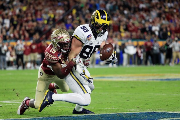 MIAMI GARDENS, FL - DECEMBER 30:  Jake Butt #88 of the Michigan Wolverines completes a pass against the defense of A.J. Westbrook #19 of the Florida State Seminoles in the first half during the Capitol One Orange Bowl at Sun Life Stadium on December 30, 2016 in Miami Gardens, Florida.  (Photo by Mike Ehrmann/Getty Images)