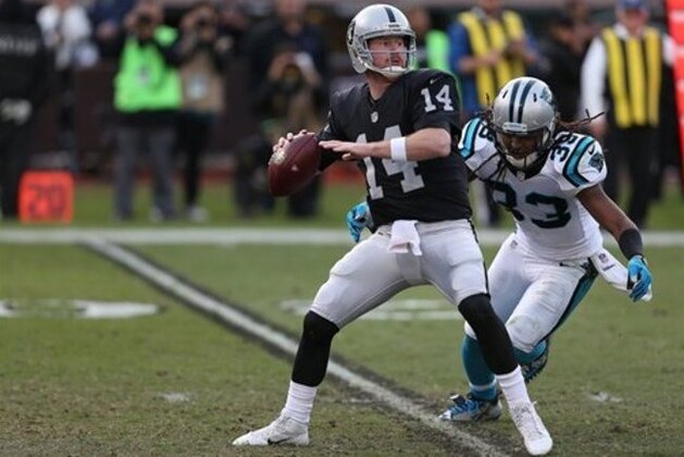 Oakland Raiders quarterback Matt McGloin (14) is chased by Tre Boston during action against the Carolina Panthers during an NFL football game Sunday, Nov. 27, 2016, in Oakland, CA. The Raiders won 35-32. (Daniel Gluskoter/AP Images for Panini)