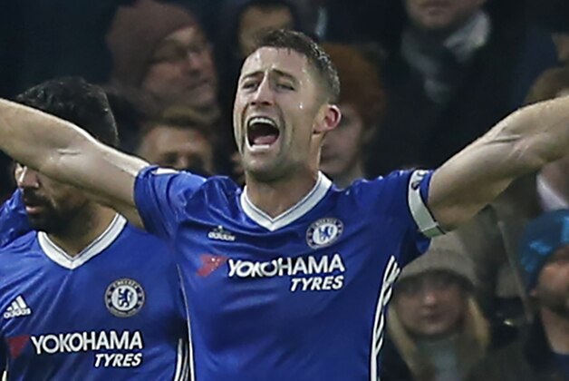 Chelsea's English defender Gary Cahill (C) celebrates after scoring the opening goal of the English Premier League football match between Chelsea and Stoke City at Stamford Bridge in London on December 31, 2016. / AFP / Ian KINGTON / RESTRICTED TO EDITORIAL USE. No use with unauthorized audio, video, data, fixture lists, club/league logos or 'live' services. Online in-match use limited to 75 images, no video emulation. No use in betting, games or single club/league/player publications.  /         (Photo credit should read IAN KINGTON/AFP/Getty Images)