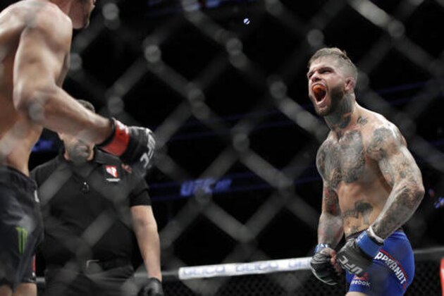 Cody Garbrandt, right, yells at Dominick Cruz during a bantamweight championship mixed martial arts bout at UFC 207, Friday, Dec. 30, 2016, in Las Vegas. (AP Photo/John Locher)