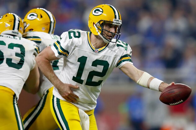 DETROIT, MI - JANUARY 1: Quarterback Aaron Rodgers #12 of the Green Bay Packers looks to hand off the football against the Detroit Lions during second half action  at Ford Field on January 1, 2017 in Detroit, Michigan (Photo by Gregory Shamus/Getty Images)