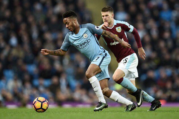 Manchester City's English midfielder Raheem Sterling (L) vies with Burnley's Icelandic midfielder Johann Berg Gudmundsson during the English Premier League football match between Manchester City and Burnley at the Etihad Stadium in Manchester, north west England, on January 2, 2017. / AFP / Oli SCARFF / RESTRICTED TO EDITORIAL USE. No use with unauthorized audio, video, data, fixture lists, club/league logos or 'live' services. Online in-match use limited to 75 images, no video emulation. No use in betting, games or single club/league/player publications.  /         (Photo credit should read OLI SCARFF/AFP/Getty Images)