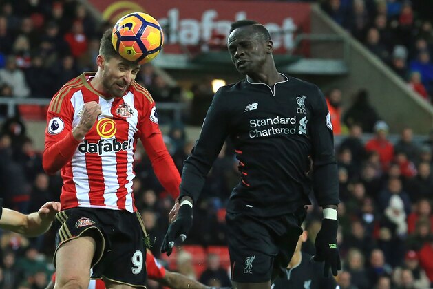Sunderland's Italian striker Fabio Borini (L) and Liverpool's Senegalese midfielder Sadio Mane compete for the ball during the English Premier League football match between Sunderland and Liverpool at the Stadium of Light in Sunderland, north-east England on January 2, 2017. / AFP / Lindsey PARNABY / RESTRICTED TO EDITORIAL USE. No use with unauthorized audio, video, data, fixture lists, club/league logos or 'live' services. Online in-match use limited to 75 images, no video emulation. No use in betting, games or single club/league/player publications.  /         (Photo credit should read LINDSEY PARNABY/AFP/Getty Images)