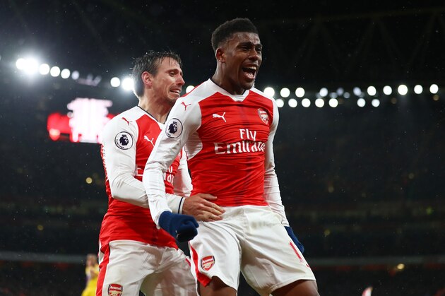 LONDON, ENGLAND - JANUARY 01:  Alex Iwobi of Arsenal celebrates with teammate Nacho Monreal (L) after scoring his team's second goal during the Premier League match between Arsenal and Crystal Palace at the Emirates Stadium on January 1, 2017 in London, England.  (Photo by Clive Mason/Getty Images)