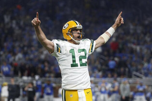 Green Bay Packers quarterback Aaron Rodgers (12) celebrates his 9-yard touchdown pass to wide receiver Davante Adams against the Detroit Lions during an NFL football game in Detroit, Sunday, Jan. 1, 2017. (AP Photo/Paul Sancya)