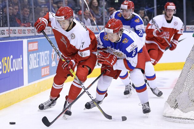 TORONTO, ON - CANADA:  Mathias Rondbjerg #7 of Team Denmark tries to protect the puck against Kirill Urakov #8 of Team Russia during a QuarterFinal game at the 2017 IIHF World Junior Hockey Championships at Air Canada Centre on January 2, 2017 in Toronto, Ontario, Canada. (Photo by Claus Andersen/Getty Images)