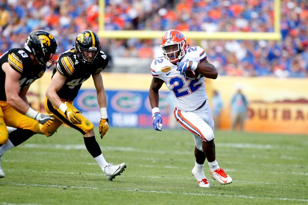 TAMPA, FL - JANUARY 2:  Running back Lamical Perine #22 of the Florida Gators evades linebacker Ben Niemann #44 of the Iowa Hawkeyes and linebacker Josey Jewell #43 during a carry in the second quarter of the Outback Bowl NCAA college football game on January 2, 2017 at Raymond James Stadium in Tampa, Florida. (Photo by Brian Blanco/Getty Images)