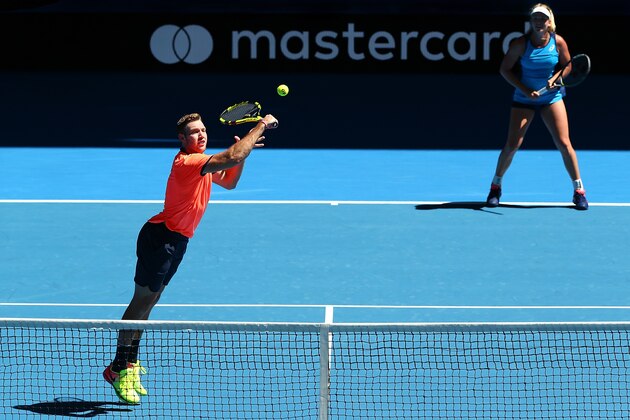 PERTH, AUSTRALIA - JANUARY 03:  Jack Sock of the United States partnered with Coco Vandeweghe plays a backhand during the mixed doubles match against Lara Arruabarrena and Feliciano Lopez of Spain on day three of the 2017 Hopman Cup at Perth Arena on January 3, 2017 in Perth, Australia.  (Photo by Paul Kane/Getty Images)