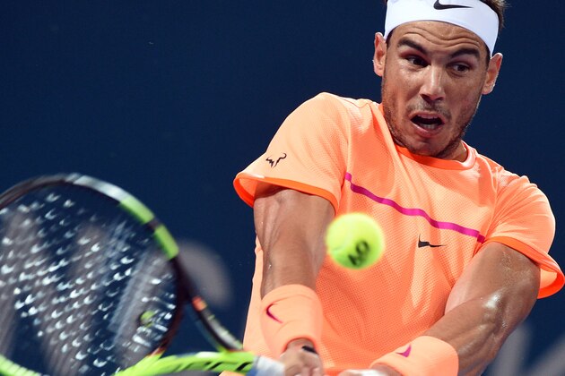 Rafael Nadal of Spain hits a return against Alexandr Dolgopolov of Ukraine in the men's round one at the Brisbane International tennis tournament in Brisbane on January 3, 2017. / AFP / SAEED KHAN / IMAGE STRICTLY RESTRICTED TO EDITORIAL USE  STRICTLY NO COMMERCIAL USE        (Photo credit should read SAEED KHAN/AFP/Getty Images)