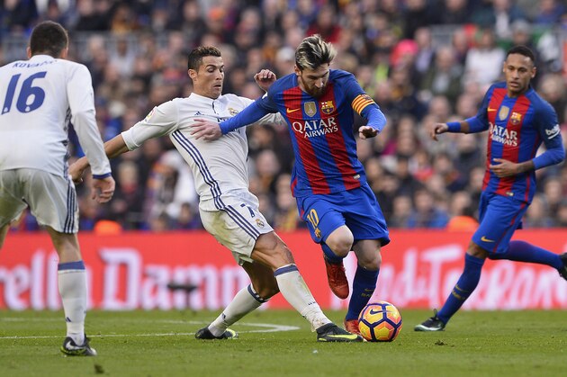 Barcelona's Argentinian forward Lionel Messi (2ndR) vies with Real Madrid's Portuguese forward Cristiano Ronaldo during the Spanish league football match FC Barcelona vs Real Madrid CF at the Camp Nou stadium in Barcelona on December 3, 2016. / AFP / JOSEP LAGO        (Photo credit should read JOSEP LAGO/AFP/Getty Images)
