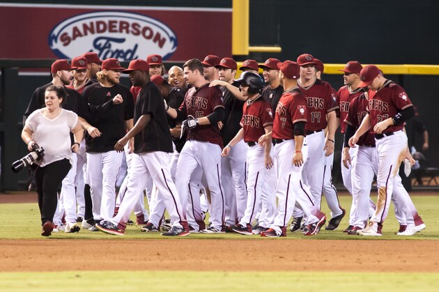 PHOENIX, AZ - OCTOBER 02: Phil Gosselin #15 of the Arizona Diamondbacks celebrates with his teammates after a walk-off single in the ninth inning of the MLB game against the San Diego Padres at Chase Field on October 2, 2016 in Phoenix, Arizona. The Arizona Diamondbacks defeated the San Diego Padres 3-2. (Photo by Darin Wallentine/Getty Images)