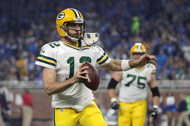 DETROIT, MI - JANUARY 01: Aaron Rodgers #12 of the Green Bay Packers scrambles during the first quarter as Devin Taylor #98 of the Detroit Lions gives chase at Ford Field on January 1, 2017 in Detroit, Michigan. Green Bay defeated Detroit 31-24. (Photo by Leon Halip/Getty Images)