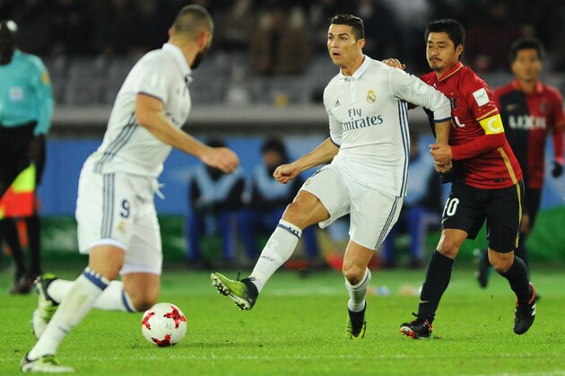 YOKOHAMA, JAPAN - DECEMBER 18: Cristiano Ronaldo of  Real Madrid and Mitsuo Ogasawara of Kashima Antlers compete for the ball during the FIFA Club World Cup final match between Real Madrid and Kashima Antlers at International Stadium Yokohama on December 18, 2016 in Yokohama, Japan.  (Photo by Hiroki Watanabe/Getty Images)