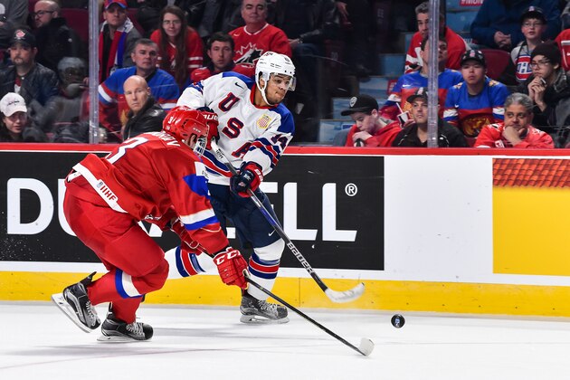 MONTREAL, QC - JANUARY 04:  Erik Foley #14 of Team United States plays the puck past Mikhail Sidorov #3 of Team Russia during the 2017 IIHF World Junior Championship semifinal game at the Bell Centre on January 4, 2017 in Montreal, Quebec, Canada.  (Photo by Minas Panagiotakis/Getty Images)