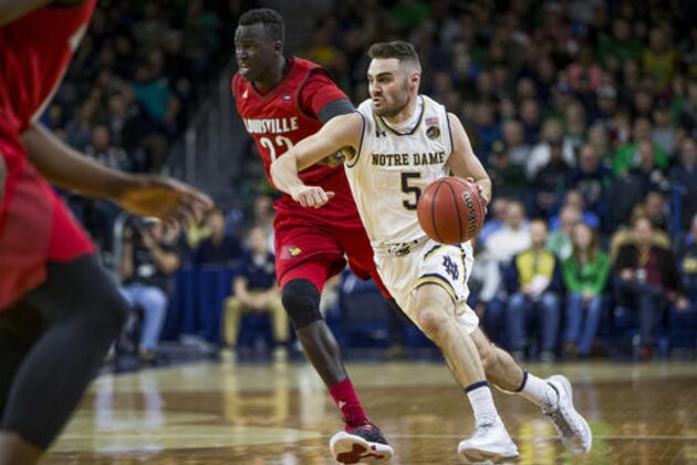 Notre Dame's Matt Farrell (5) drives by Louisville's Deng Adel (22) during the first half of an NCAA college basketball game Wednesday, Jan. 4, 2017, in South Bend, Ind. (AP Photo/Robert Franklin)